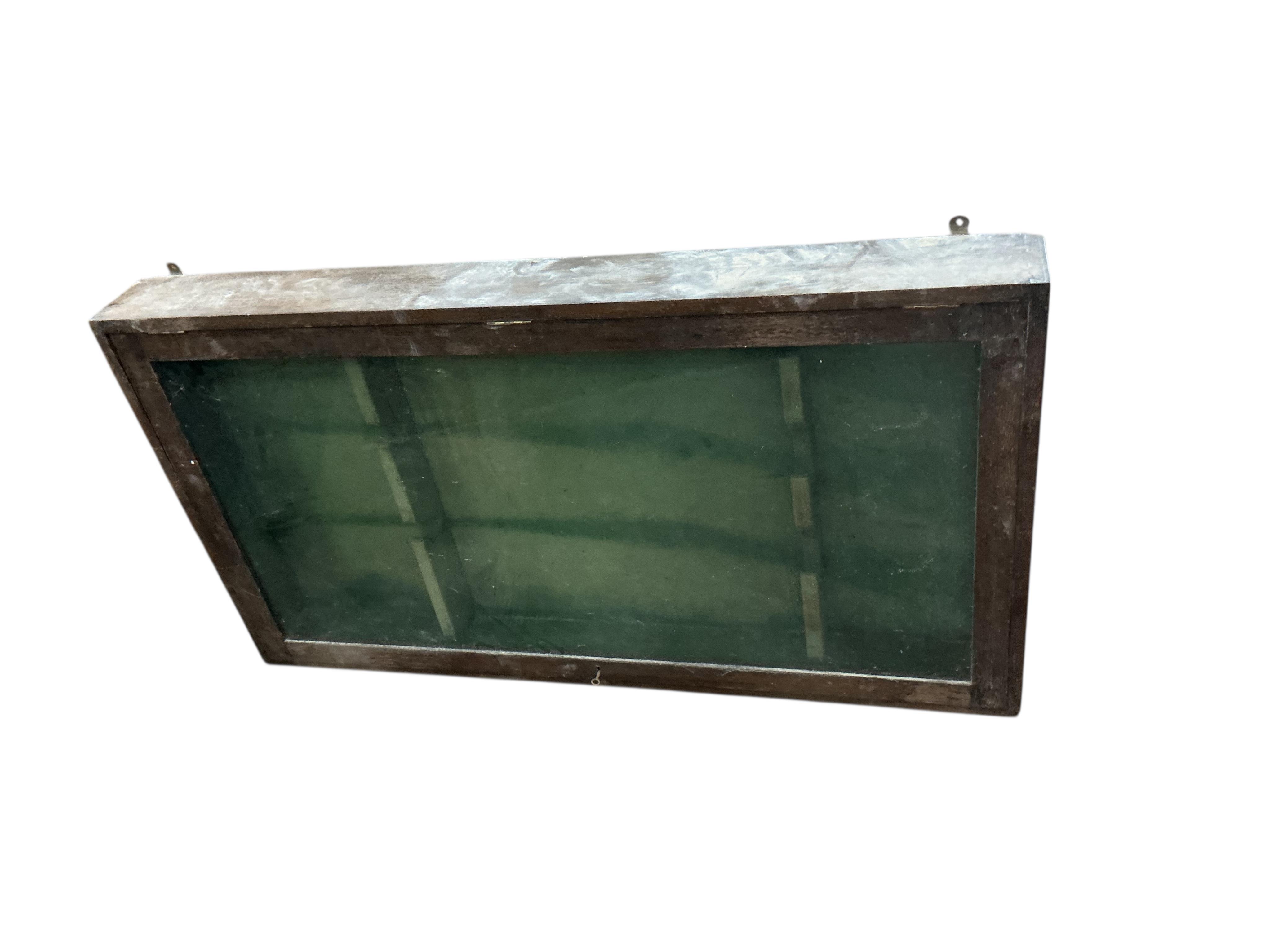 An oak hanging gun cabinet, width 134cm, depth 14cm, height 74cm